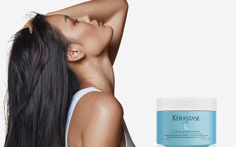 Kerastase Fusio Scrub model with hair care products for scalp care.