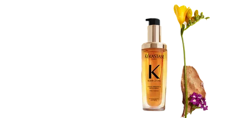 Kerastase Elixir Ultime Hair Oil bottle next to flowers