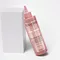 Bottle of Chroma Absolu Chroma Gloss Treatment leaning on a white block