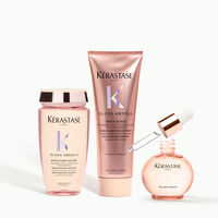 3 Kerastase Gloss Aboslu product bottles on a minimal background