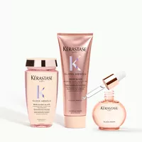 3 Kerastase Gloss Aboslu product bottles on a minimal background
