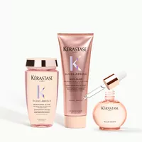 3 Kerastase Gloss Aboslu product bottles on a minimal background