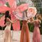 3 Kerastase models with sleek shiny hair surrounded by roses