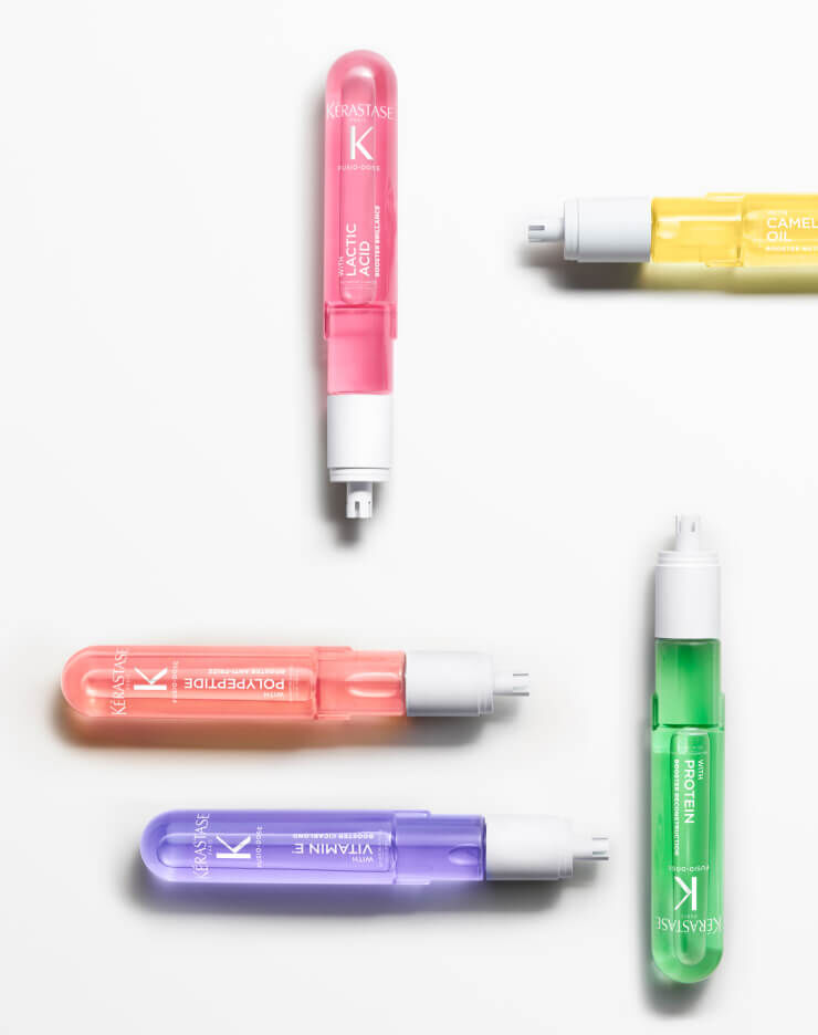5 Fusio-Dose hair treatment bottles on a white background