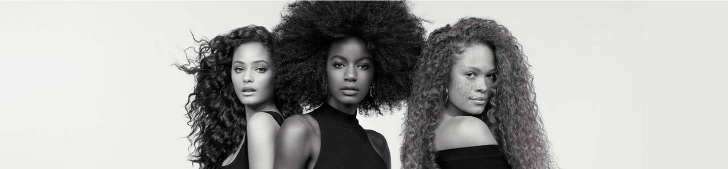 3 models with curly hair with a black and white effect
