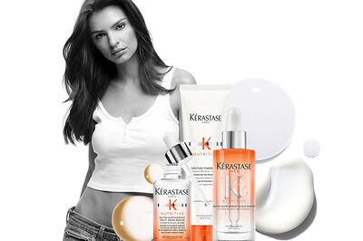 Model with the Kerastase Nuritive hair routine on a white background