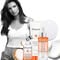 Model with the Kerastase Nuritive hair routine on a white background