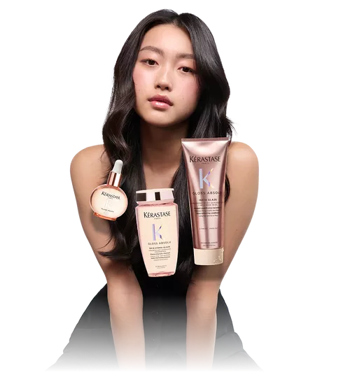 Model with sleek dark hair and 3 Kerastase Gloss Absolu products