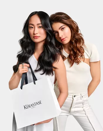 Two models with Kerastase branded gift bag