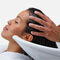 A woman has her hair washed at a hair salon