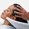 A woman has her hair washed at a hair salon