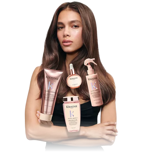Model with sleek rown hair and the complete Kerastase Gloss Absolu products line