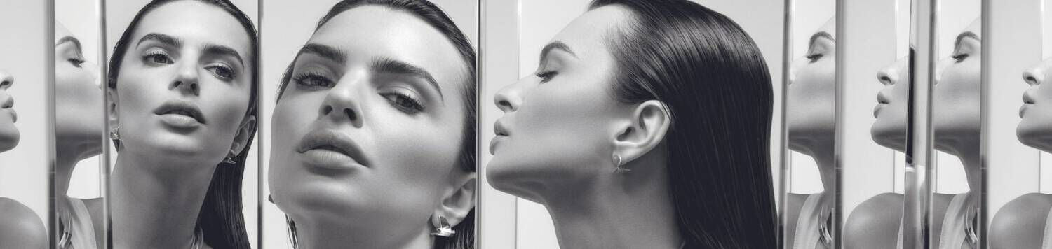 Monochrome portrait of woman with sleek hair reflected in mirrors