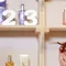 Hair consultation scene with stylist examining woman's hair in salon