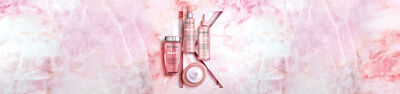 Kerastase Chroma Absolu hair care collection on pink marble background