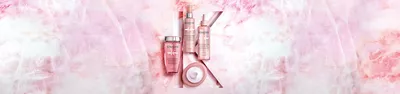 Kerastase Chroma Absolu hair care collection on pink marble background