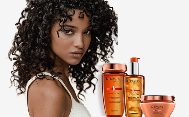 Kerastase Discipline model with hair care for frizzy hair.