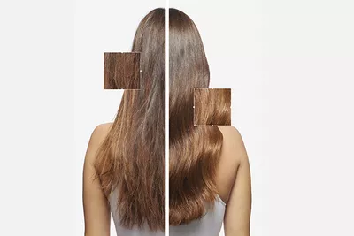 Model shows her shiny healthy dark hair after using Elixir Ultime hair oil.