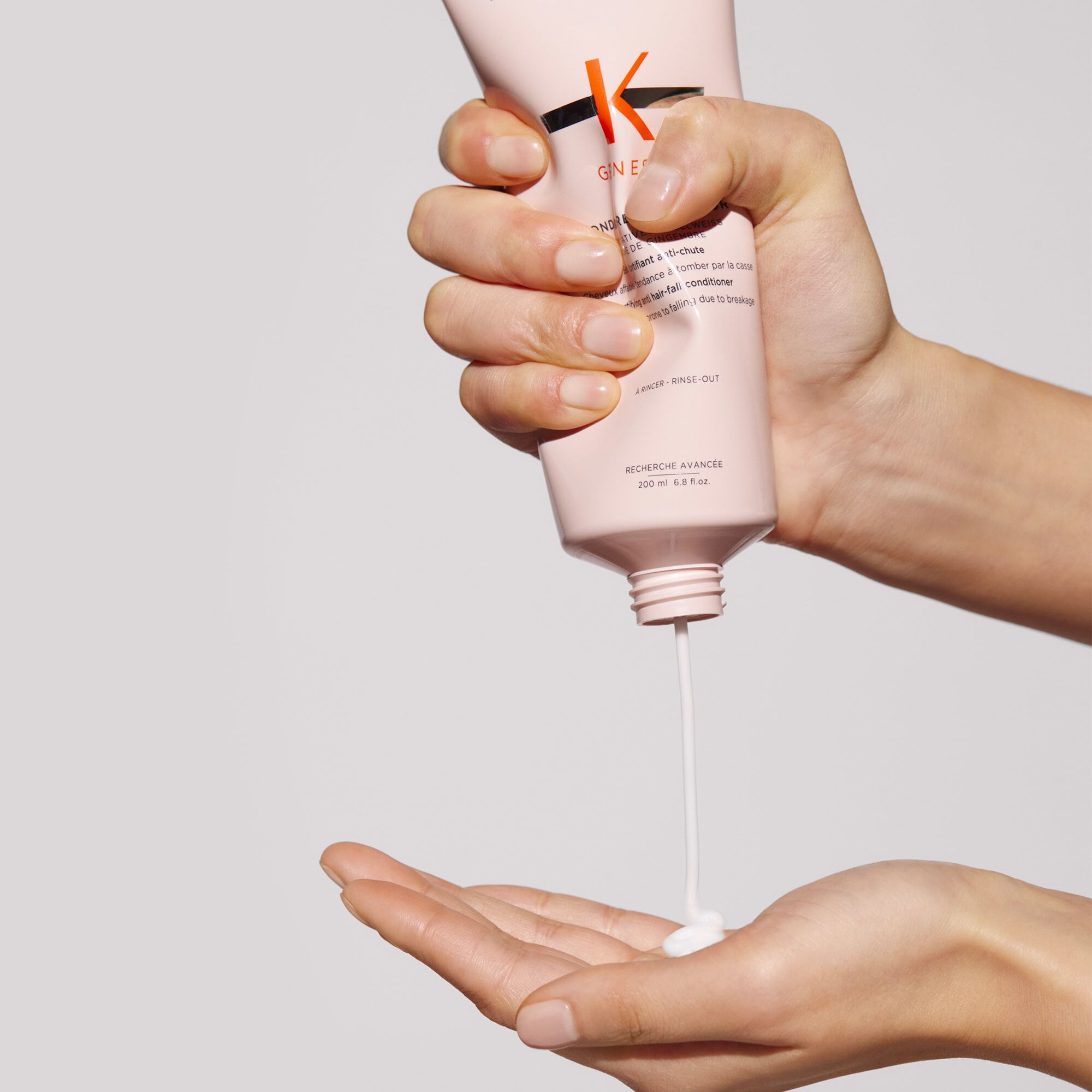 Kerastase Fondant Renfocateur Genesis Conditioner to fortify hair product in hand