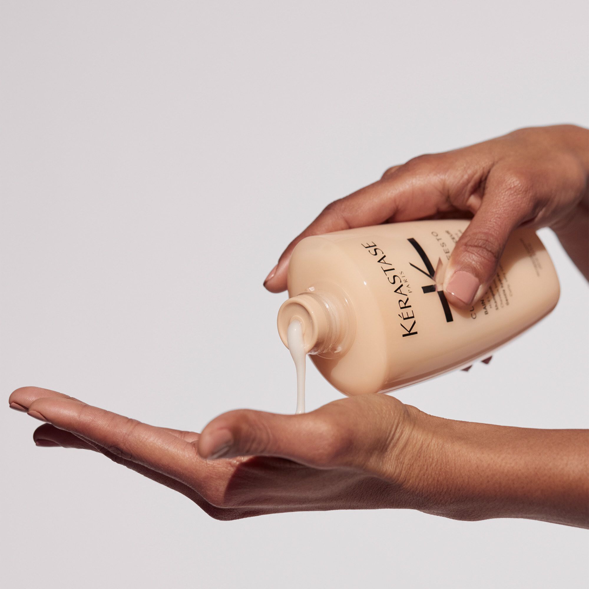 Kerastase Bain Hydratation Douceur Curl Manifesto Shampoo for curly hair product in hand