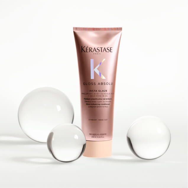 Gloss Absolu Conditioner bottle surrounded by glass decor
