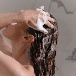 A woman washes her hair